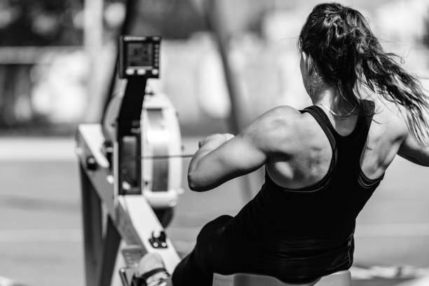 female athlete on rowing machine, black and white